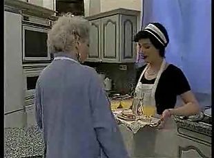 French maid fists a mature slut in the kitchen